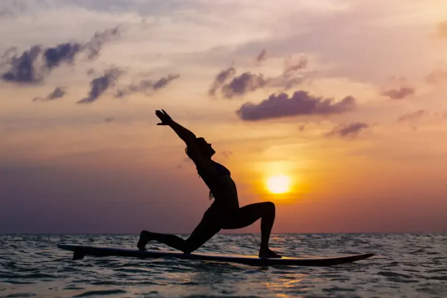 surf and yoga during the sunset