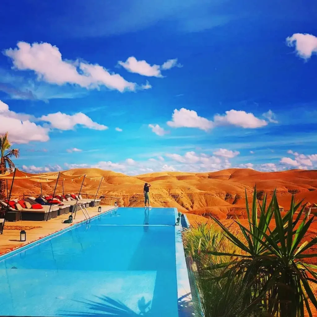 Unleash Your Inner Adventurer: Thrilling Activities and Relaxing Escapes in the Agafay Desert with Maroc Day Pass Maroc Day Pass Beautiful view of the Piscine A Agafay swimming pool Agafay Luxury Camp against a backdrop of awe-inspiring Moroccan landscapes for a unique camping experience